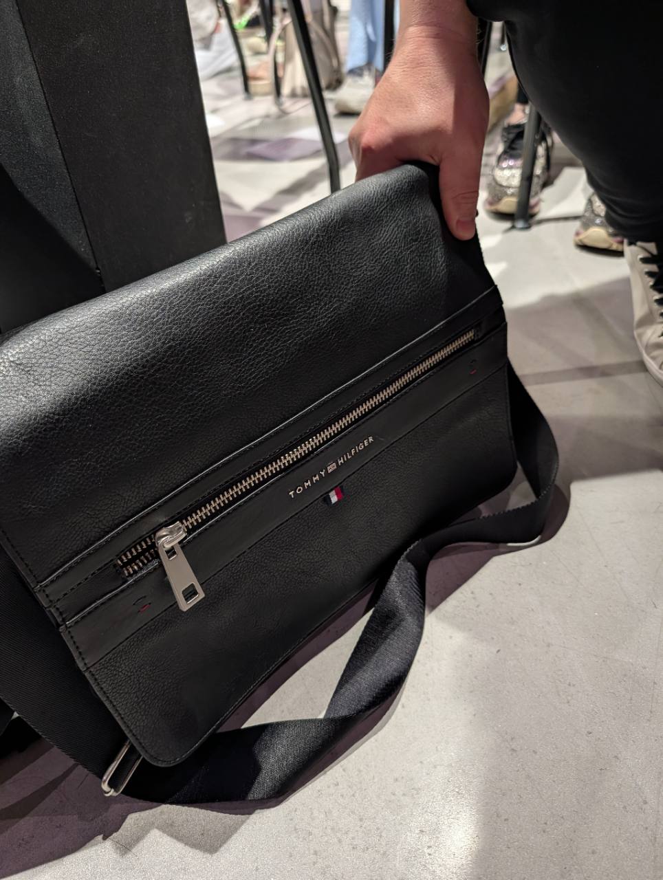 Black Tommy Hilfiger flap messenger bag with front zipper